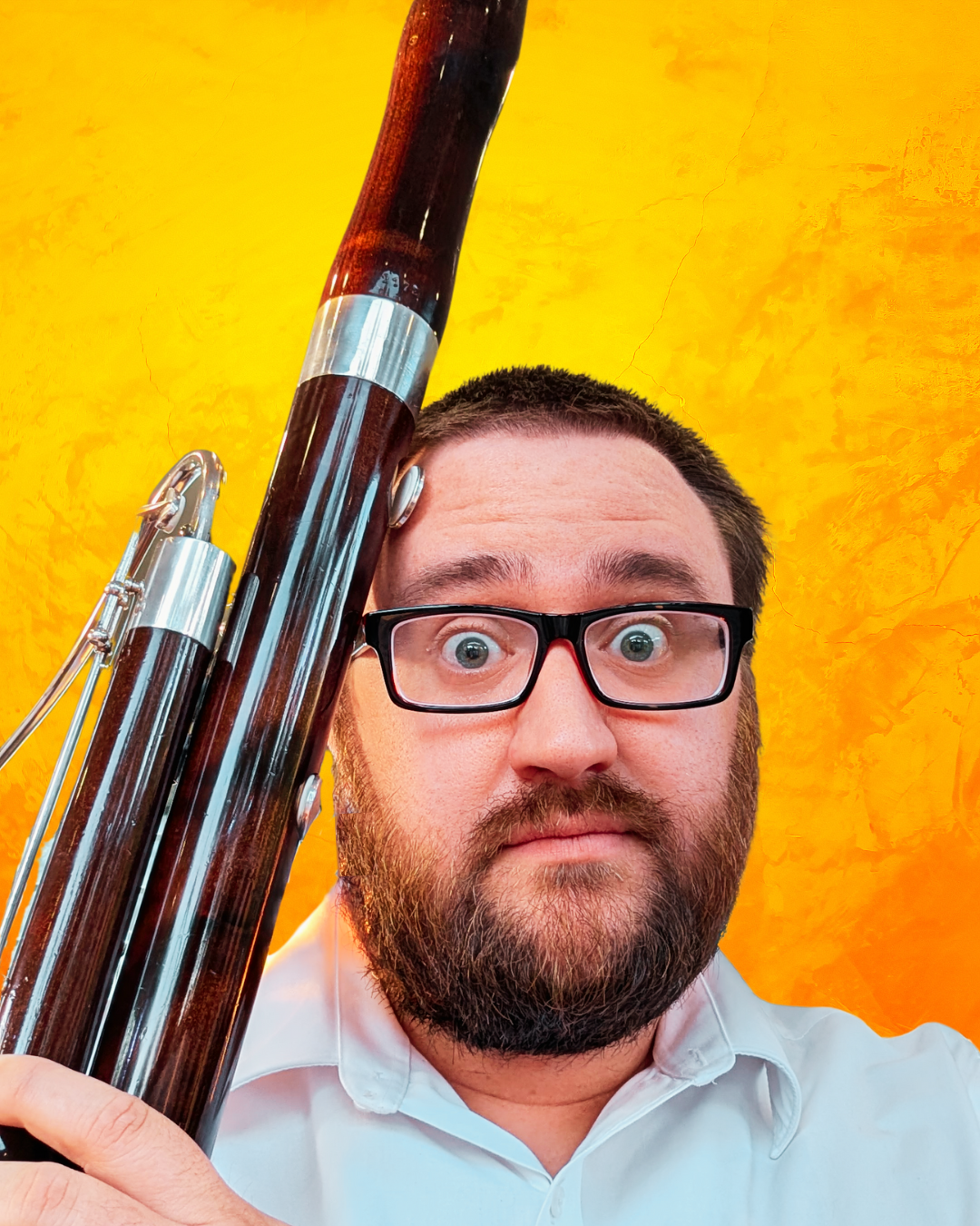 Jack Barton holding a bassoon in front of a yellow background
